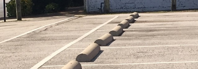 concrete wheel stops in parking lot